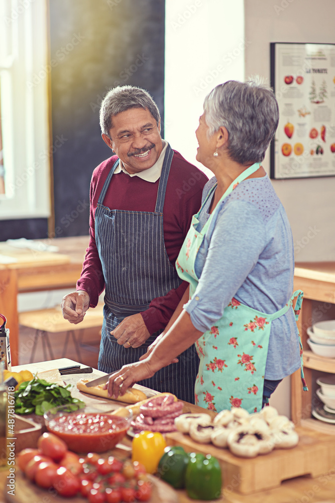 Sticker Its a healthy and happy retirement. Shot of a mature couple cooking together at home.