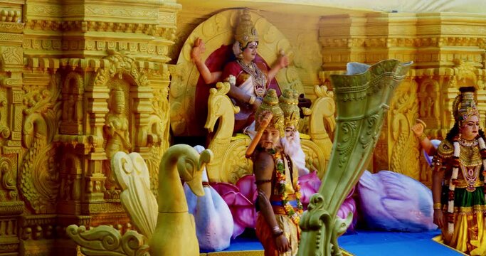 A grand tableau portraying Hindu Goddess Lakshmi along with Brahma and Vishnu moving forward slowly during the Tiger Dance Festival in Cochin, Kerala.