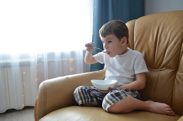 child eating on the sofa