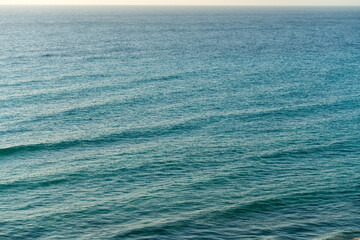 surface in the turquoise sea with small ripples