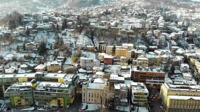 Morning drone shot during winter in Bosnia's capital Sarajevo. A day after the snow has fallen. Sarajevo is known for its siege during the 90s ethnic war that lasted almost 4 years.