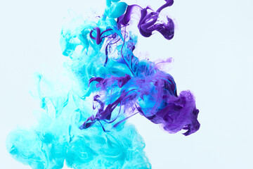 Blue and purple paint splash curves in water on white. Acrylic paint drop background. Abstract...