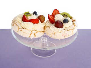 tasty meringue cake with cream and fruits