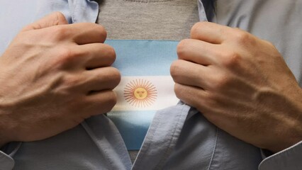Man unbuttons his shirt and shows the flag of Argentina. Freedom and national pride. Rights for Independence. Patriotism.