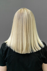 Modern trendy AirTouch or shatush technique for hair bleaching. Look from behind on straight hair