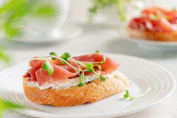Italian breakfast with prosciutto, cream cheese and micro greens. Mediterranean food concept