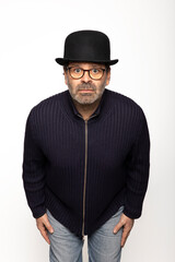 Portrait middle-aged man with glasses, bowler hat and round glasses, is leaning forward