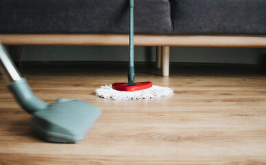 cleaning floor with vacuum, wooden floor.