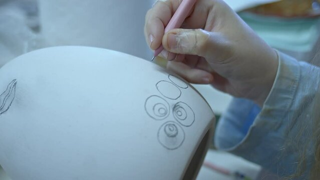 Working in a Ceramic Workshop Drawing and Painting Huge Easter Paschal Egg