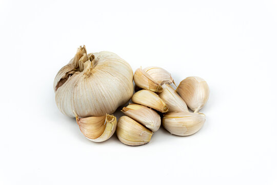 head and garlic cloves isolated on white background