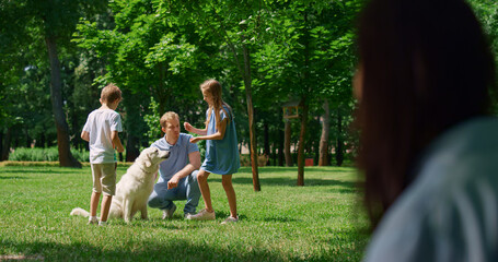 Blurred profile unknown woman looking resting family on summer picnic.