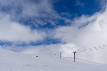 Fototapeta na wymiar Image of a snow covered mountain plateau. Tourists walk and take pictures on a mountain plateau.