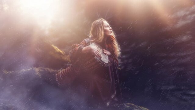 beautiful shamanic girl playing on drum in the nature.