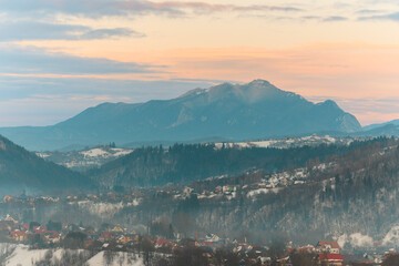 Spectacular sunset evening in Transylvania, Romania is the ideal time to go out and capture beautiful aerial photography. Sunset aerial with Moeciu and Bran in Brașov County, Transylvania, Romania