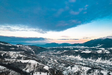 Sunset aerial with Moeciu and Bran in Brașov County, Transylvania, Romania. Bran, Simon included in the historical sub-region of Tara Barsei, Burzenland. Search for wilderness, nature, and countryside