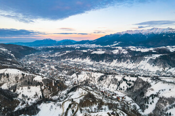 Sunset aerial with Moeciu and Bran in Brașov County, Transylvania, Romania. Bucegi Mountains on...