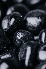 Black stones reflect the light of the sun