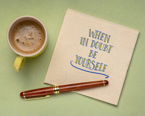 when in doubt be yourself - inspirational advice and reminder, handwriting on a napkin with a cup of coffee, personal development concept