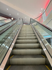 Shopping mall escalator. Moving staircase. Ascent and descent in the interior. Move up or down stairs.