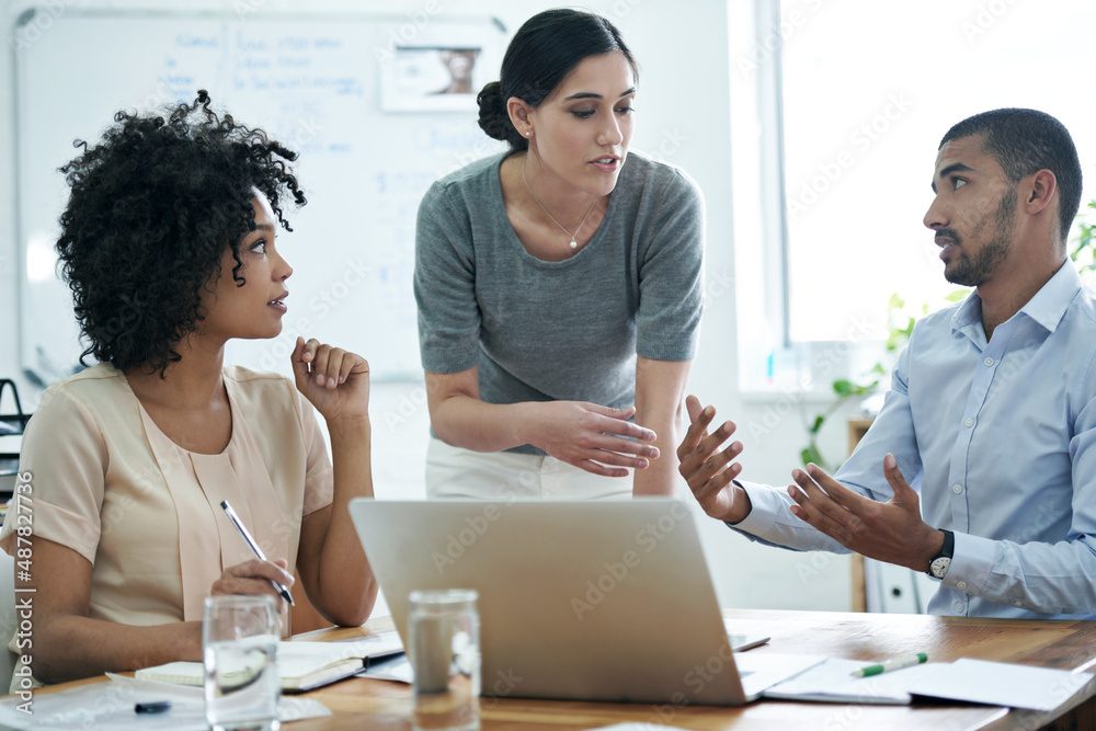 Poster Talking their way to innovative concepts. Shot of a group of professionals using wireless technology during a meeting.