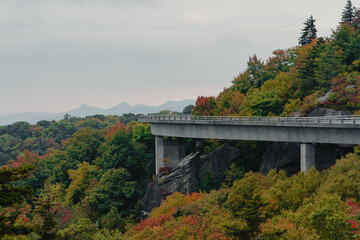 Scenic mountain viewpoint with colorful leaves and bridge during the fall season