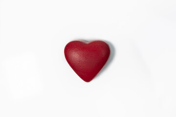 Chocolate candy in shape of a red heart.