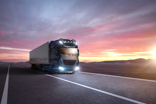 Truck driving on a highway at sunset