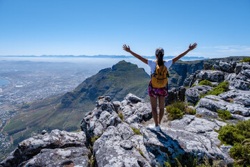 Fototapeta premium view from the Table Mountain in Cape Town South Africa, view over the ocean, and Lion's Head from Table Mountain Cape Town. woman visit mountain