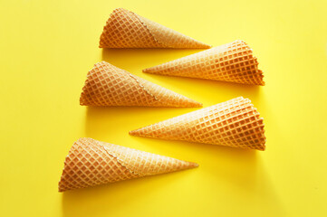 five waffle cups lie on a yellow background