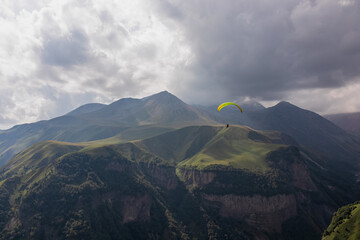 Paragliding in Gudauri Recreational Area in the Greater Caucasus Mountains in Georgia. Clouds are...