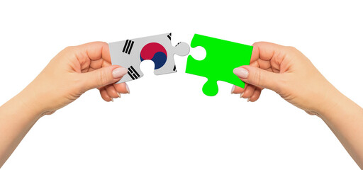 Woman hands are holding part of puzzle game. National mock up on white background. Korea South