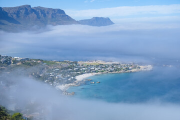 View from The Rock viewpoint in Cape Town over Campsbay, view over Camps Bay with fog over the ocean. fog coming in from ocean at Camps Bay Cape Town