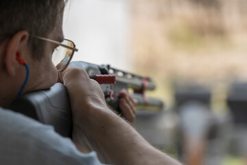 Man shoots with a combat shotgun at targets on shooting range