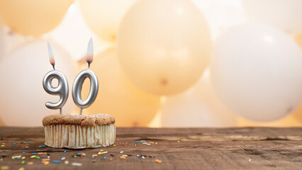 Happy birthday card with candle number 90 in a cupcake against the background of balloons. Copy...