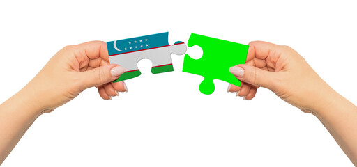 Woman hands are holding part of puzzle game. National mock up on white background. Uzbekistan