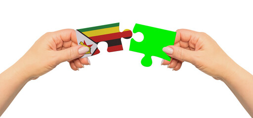 Woman hands are holding part of puzzle game. National mock up on white background. Zimbabwe