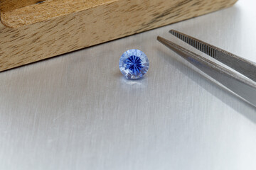 Naklejka premium macro mineral faceted stone Sapphire on a gray background