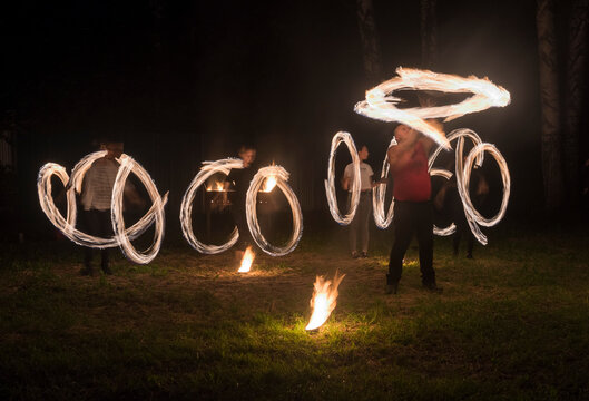 Russia. Kuzbass. Evening fire show at the closing of the festival of traditional Slavic culture "Gifts of Siberia", located in the pine-birch forest.