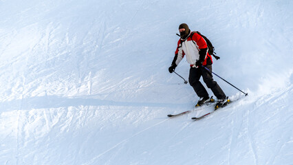 Skier riding on a ski track in the Carpathians in winter, Romania
