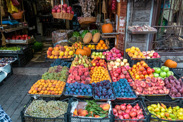 Various fruits for sale on a local outdoor market in the city center of Tbilisi, Georgia. Close View of fresh fruits in tray on showcase of local food market, Bazaar. Food tour. Vegetables and Fruits.