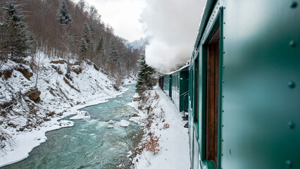 Moving steam train Mocanita from inside it in winter, Romania
