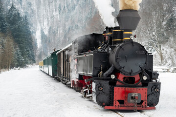 Steam train Mocanita on a railway station in winter, Romania