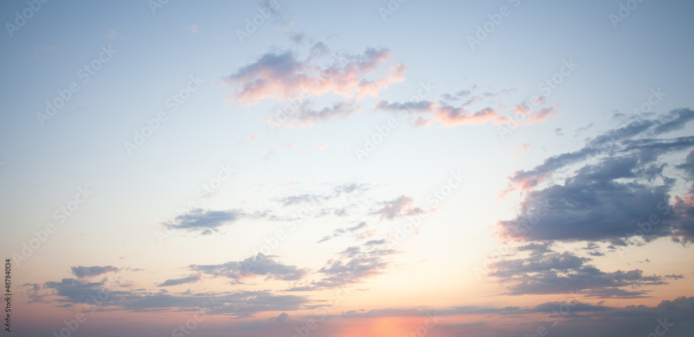 Wall mural blue sky clouds background. beautiful landscape with clouds and orange sun on sunset sky
