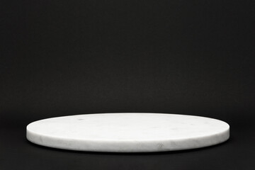 empty round marble tray on black background for presentation of various products, stone podium