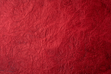 Textured crumpled red paper background.