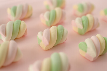 Colorful marshmallows composition on a pink background - copy space