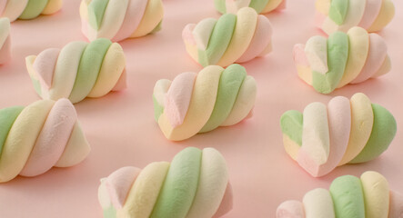 Colorful marshmallows composition on a pink background - copy space