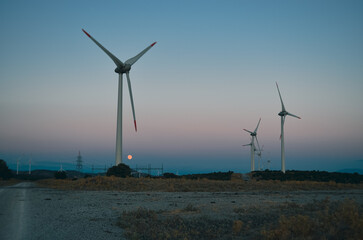 wind towers at sunset silhouette