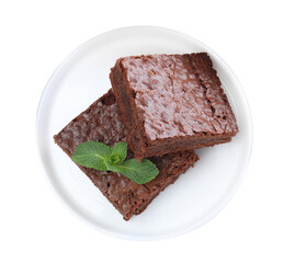 Pieces of delicious chocolate brownie with fresh mint on white background, top view