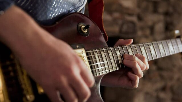 Close-up of person playing a guitar solo on an electric guitar